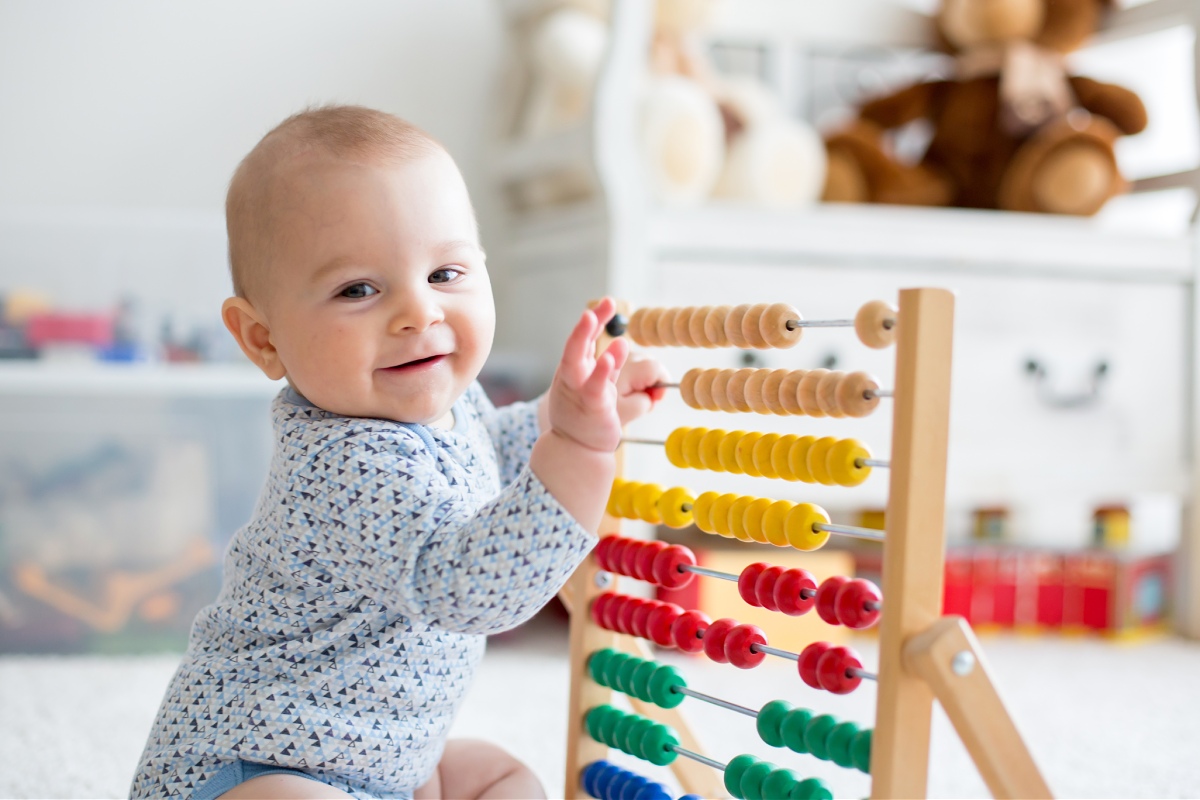 baby playing with abacus at home